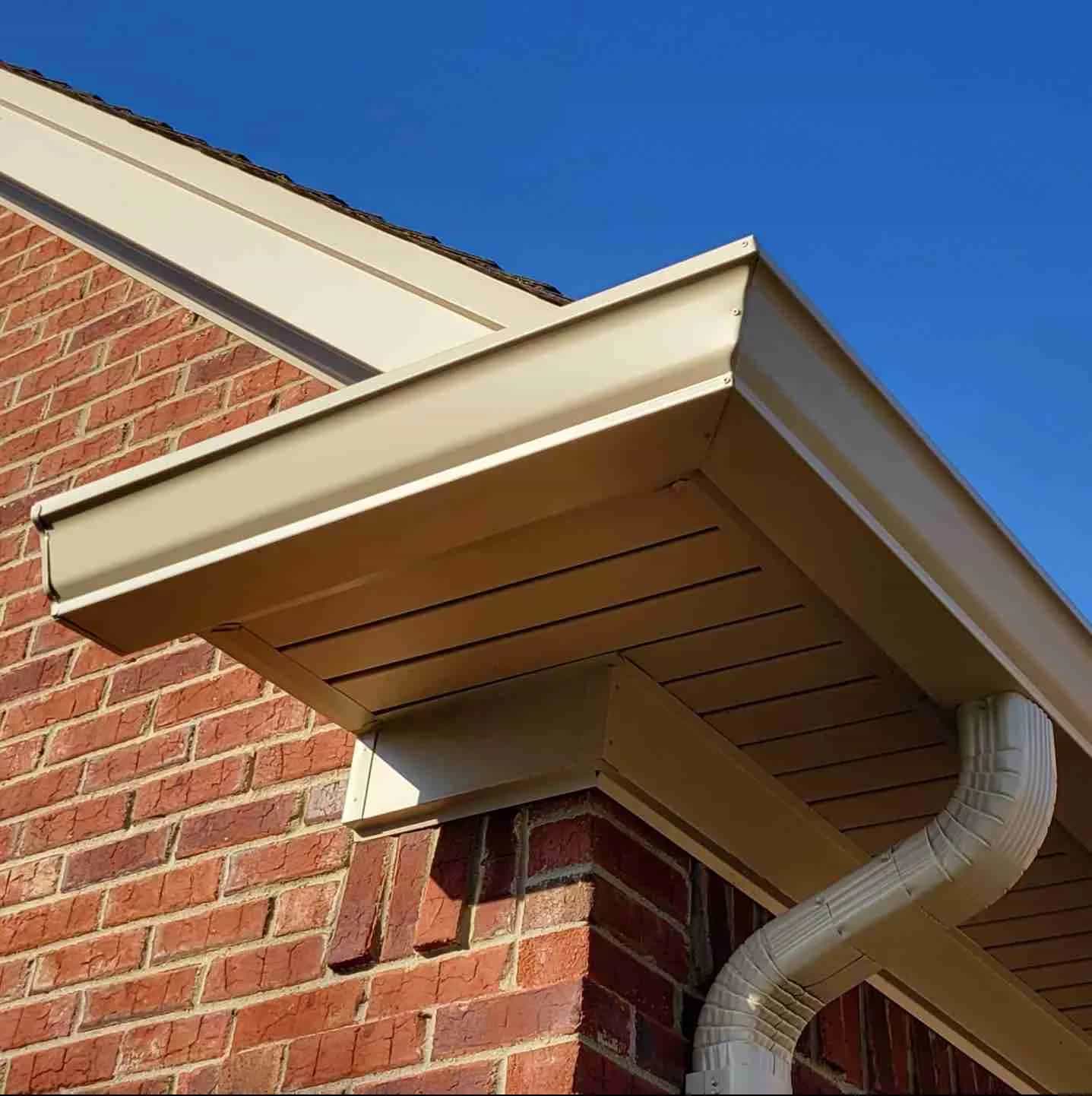 5 Inch and 6 Inch Seamless Gutter Installation in SE Michigan tan seamless gutters on a brick house corner