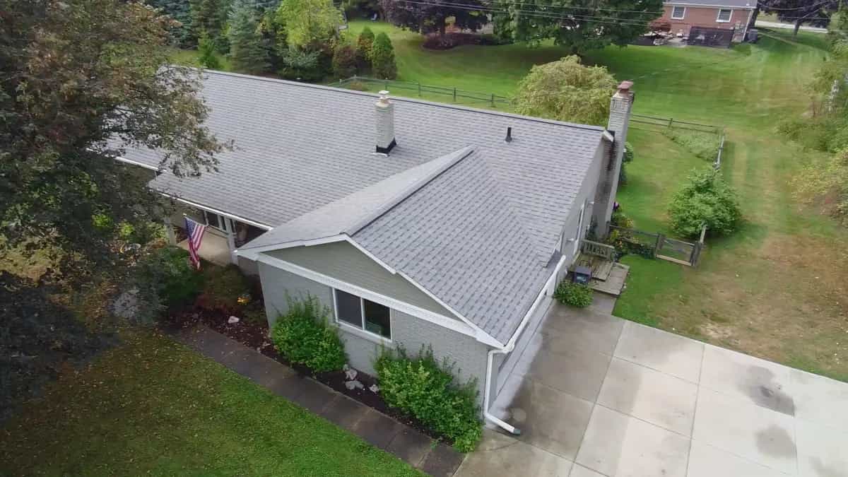 Aerial view of a Michigan ranch home with new siding, trim, and gutters after a Roofing Army roof replacement