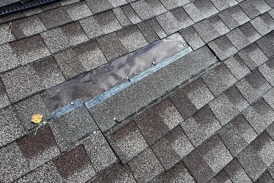 wind damaged shingles blown off on a roof