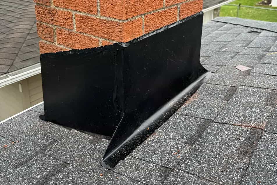 hand crafted chimney flashing on a brick chimney