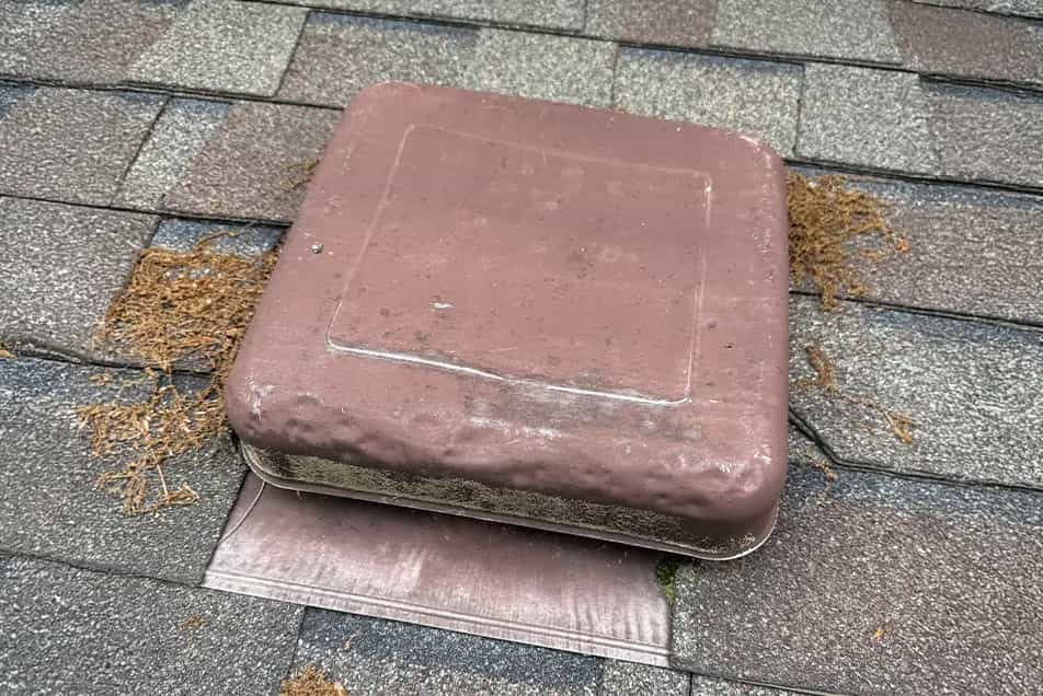 Dented Vents - SE Michigan Storm Damage Roofing box vent with hail impact dents on it