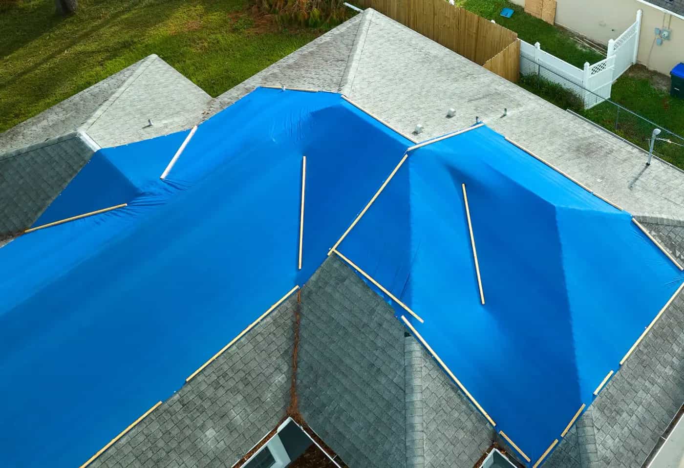 Emergency roof tarping to protect a Michigan home from further damage
