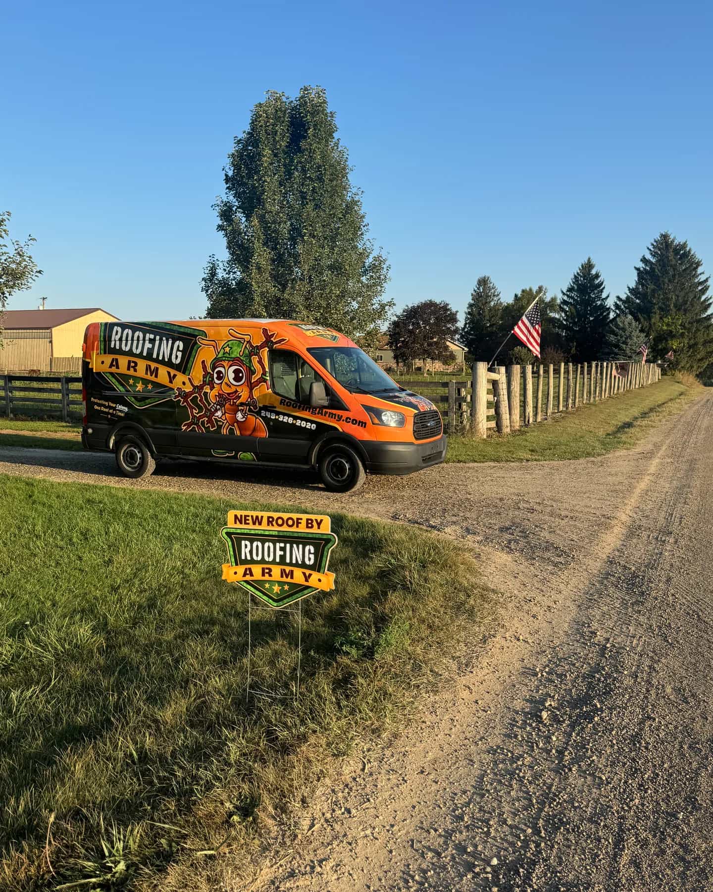 A Roofing Army van and yard sign outside a completed roof replacement in Michigan