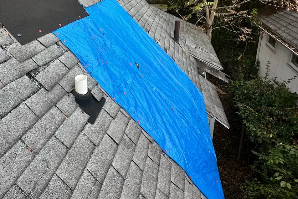 asphalt shingle roof in michigan with emergency tarping to cover damage