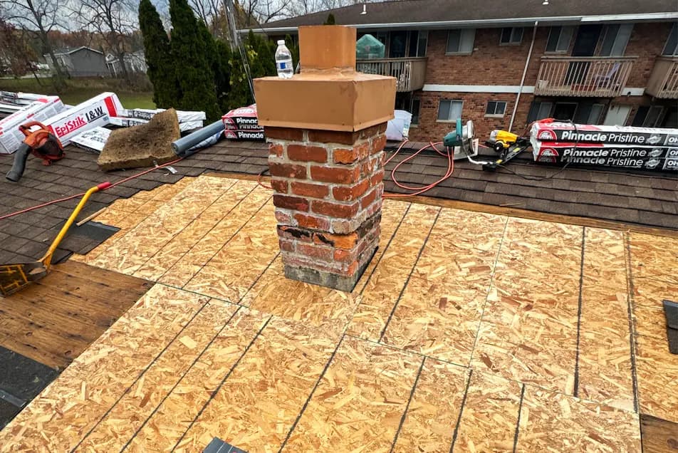 sheets of osb plywood around a brick chimney repair in michigan