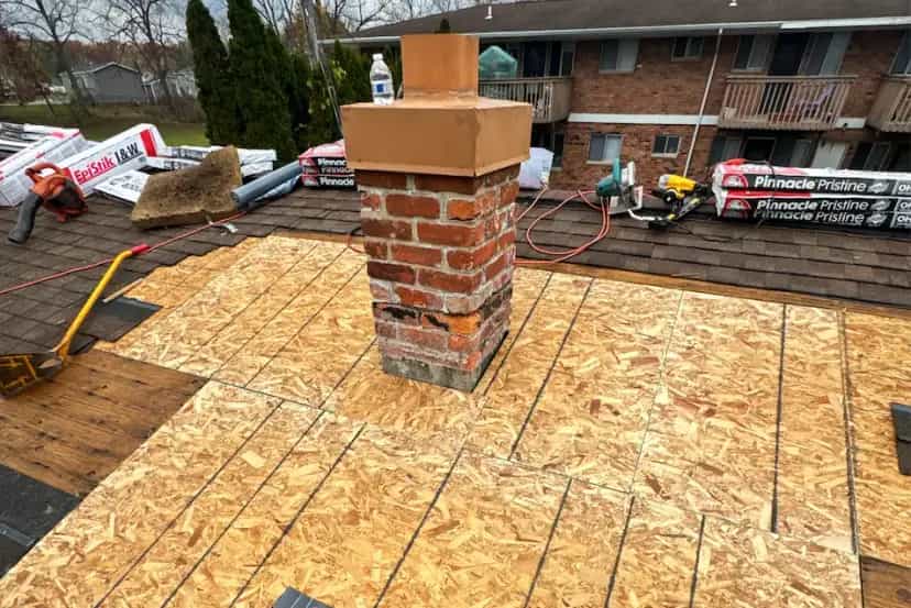 Roof Repair Services in Southeast Michigan - Roofing Army sheets of osb plywood around a brick chimney repair in michigan