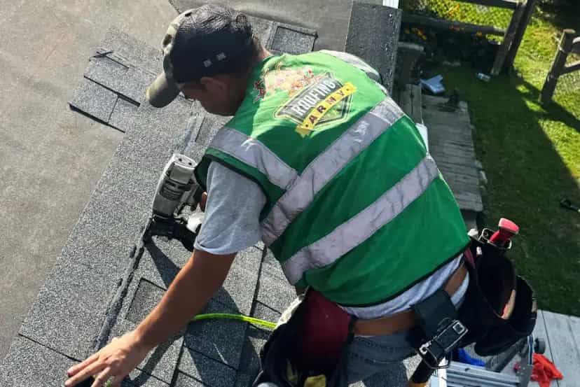 Roof Replacement Services in Southeast Michigan - Roofing Army a roofer nailing a shingle on a roof replacement job in michigan