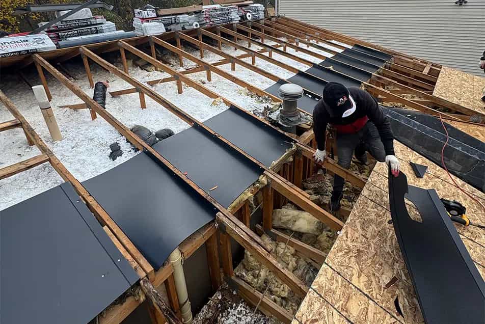 Attic Ventilation - Roof Replacement in SE Michigan open roof showing attic rafters insulation and insulation baffles