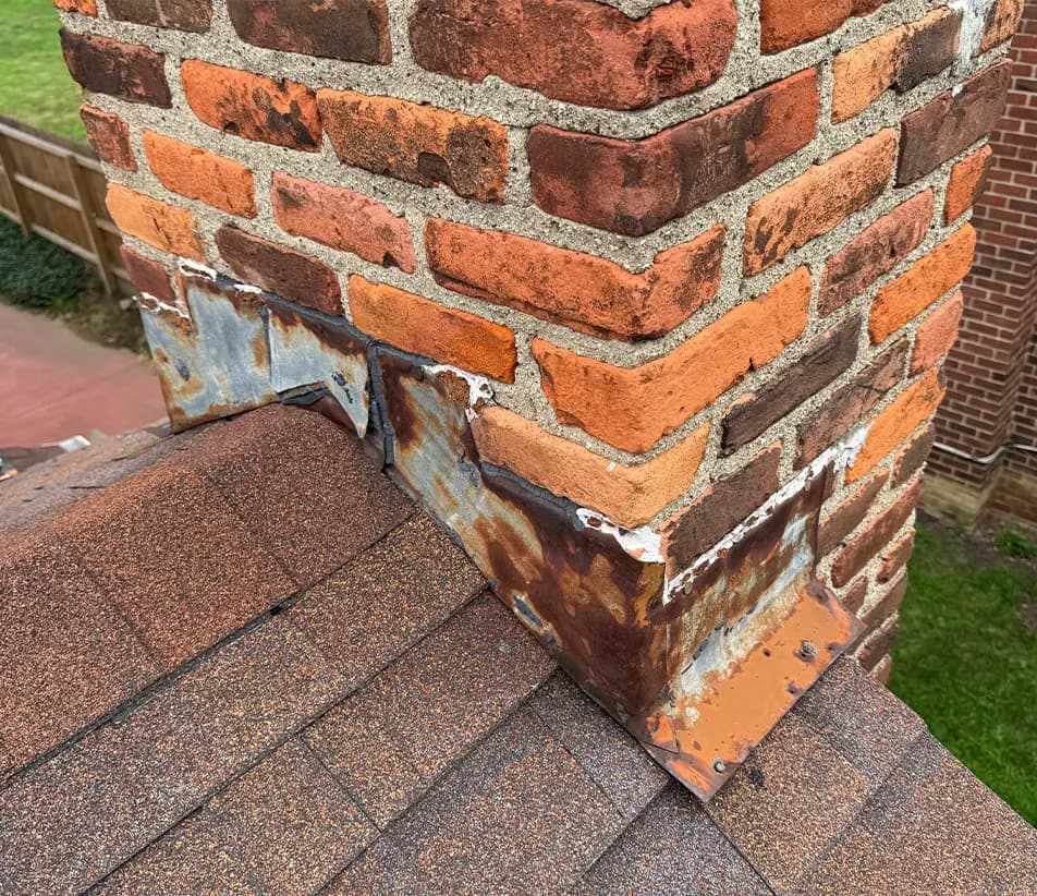 old chimney flashing on a brick chimney