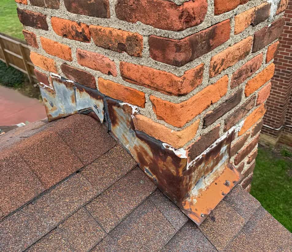 Chimney Flashing - SE Michigan Roof Repair Services old chimney flashing on a brick chimney