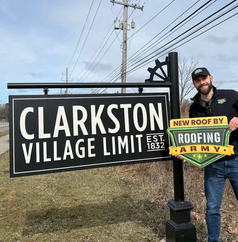 Aaron Scott, owner of Roofing Army, standing in front of the Clarkston welcome sign in Clarkston, Michigan Aaron Scott, owner of Roofing Army, standing in front of the Clarkston welcome sign in Clarkston, Michigan