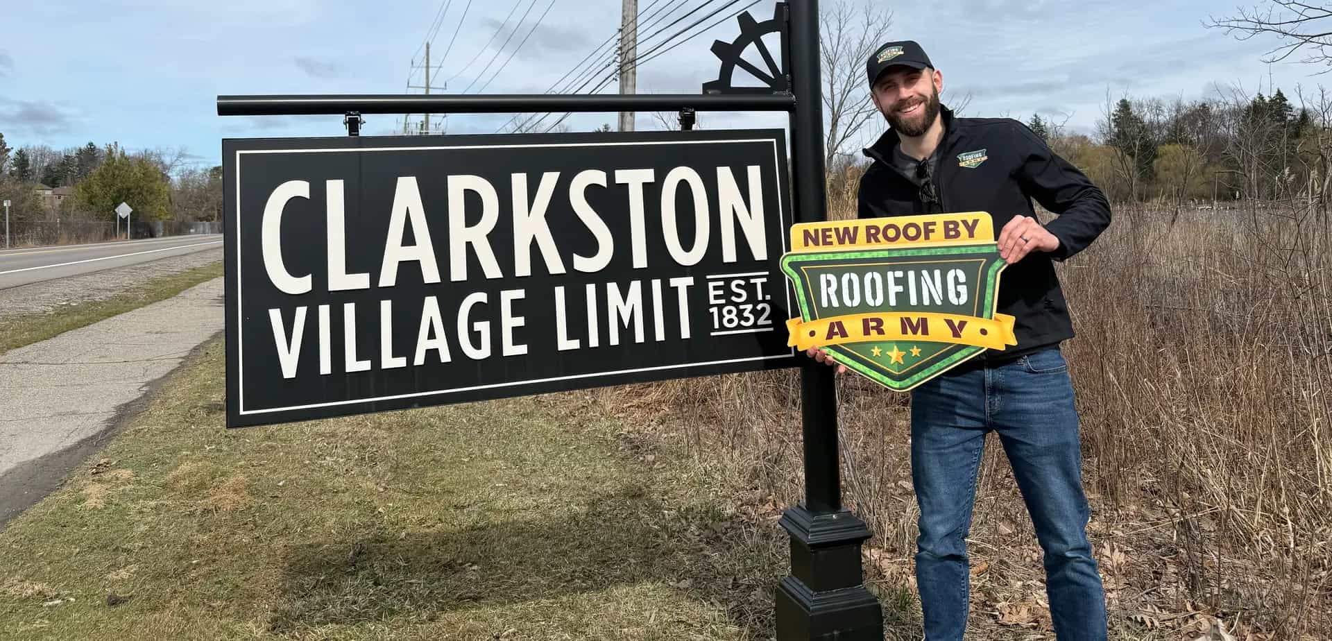 Aaron Scott, owner of Roofing Army, standing in front of the Clarkston welcome sign in Clarkston, Michigan Aaron Scott, owner of Roofing Army, standing in front of the Clarkston welcome sign in Clarkston, Michigan
