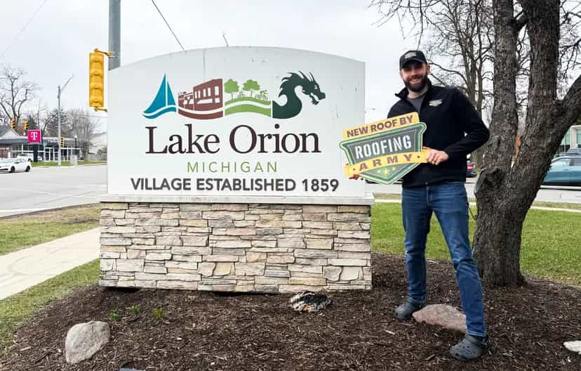 Aaron Scott, owner of Roofing Army, standing in front of the Lake Orion welcome sign in Lake Orion, Michigan Aaron Scott, owner of Roofing Army, standing in front of the Lake Orion welcome sign in Lake Orion, Michigan