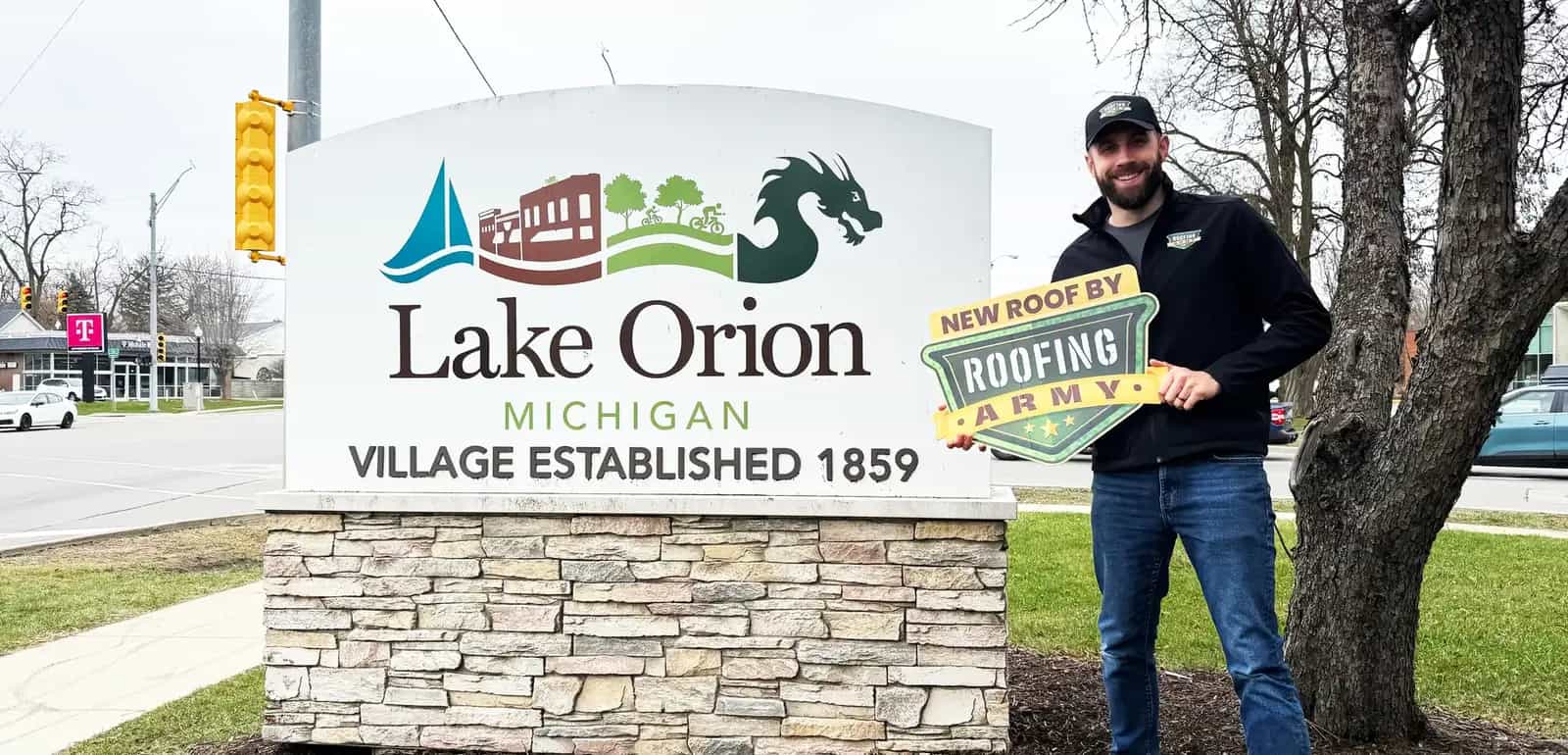 Aaron Scott, owner of Roofing Army, standing in front of the Lake Orion welcome sign in Lake Orion, Michigan Aaron Scott, owner of Roofing Army, standing in front of the Lake Orion welcome sign in Lake Orion, Michigan
