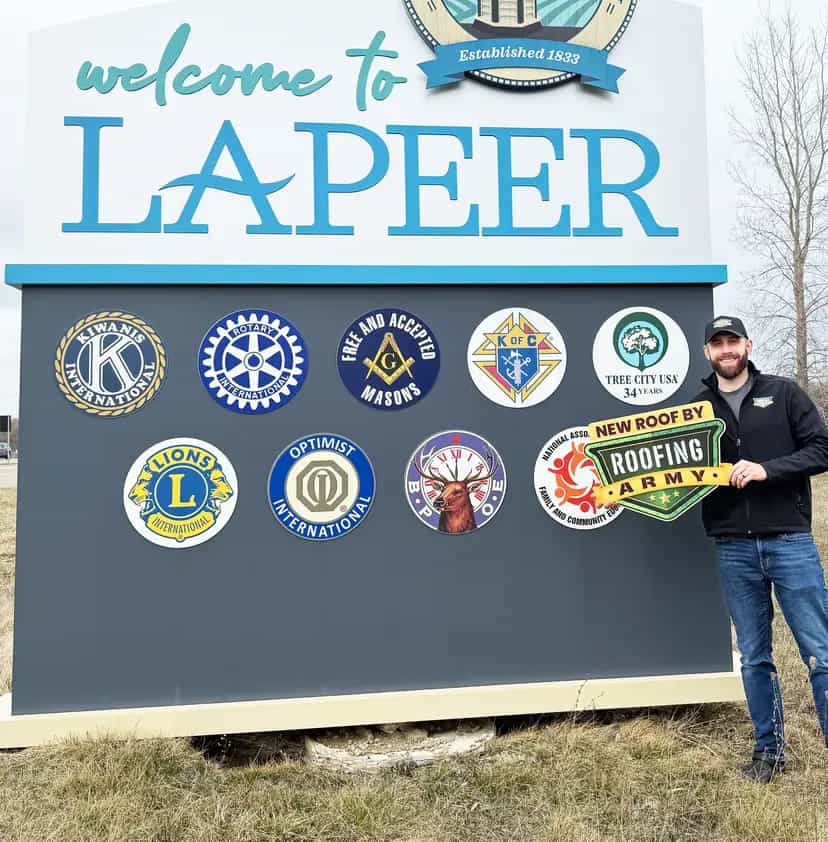 Aaron Scott, owner of Roofing Army, standing in front of the Lapeer welcome sign in Lapeer, Michigan Aaron Scott, owner of Roofing Army, standing in front of the Lapeer welcome sign in Lapeer, Michigan