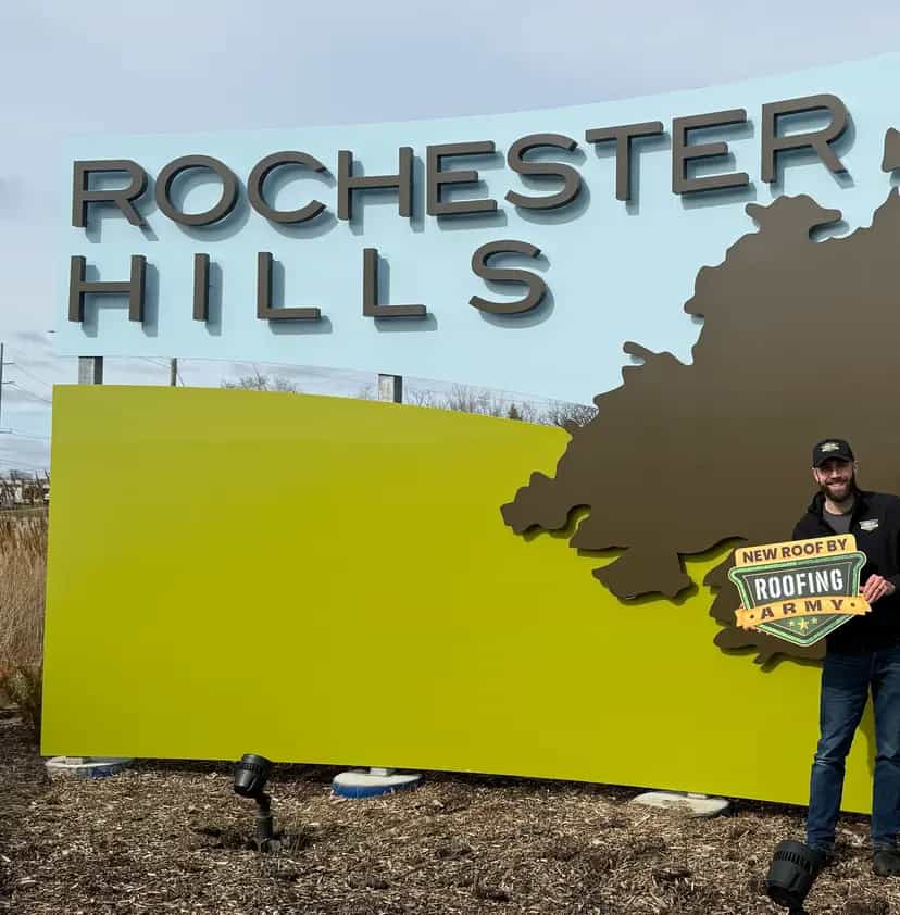 Aaron Scott, owner of Roofing Army, standing in front of the Rochester Hills city sign in Rochester Hills, Michigan Aaron Scott, owner of Roofing Army, standing in front of the Rochester Hills city sign in Rochester Hills, Michigan