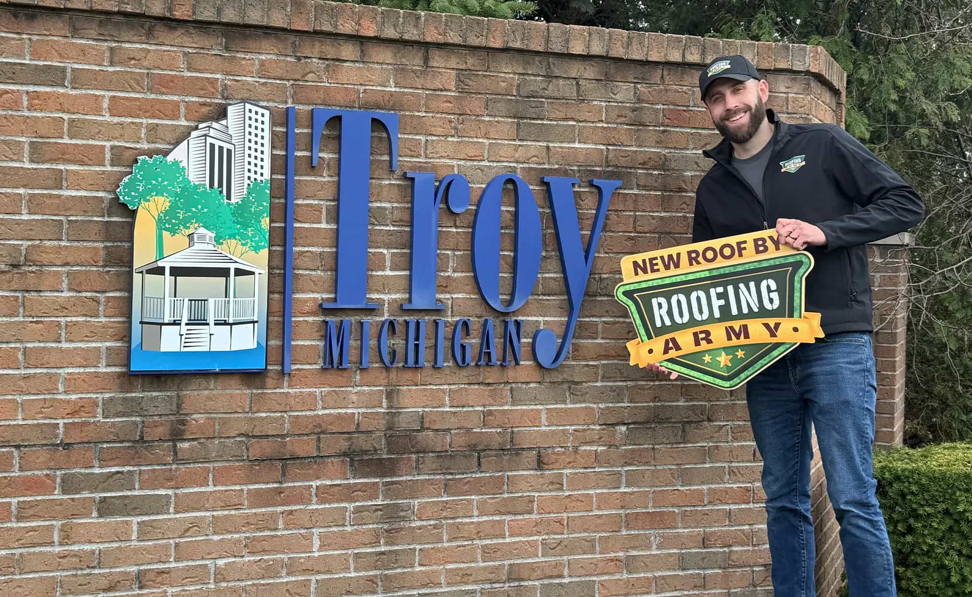 Aaron Scott, owner of Roofing Army, standing in front of the Troy city sign in Troy, Michigan Aaron Scott, owner of Roofing Army, standing in front of the Troy city sign in Troy, Michigan