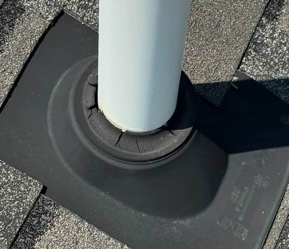 Bad Pipe Boots - Michigan Roof Repair Services pipe boot flashing showing a broken and cracked gasket around pvc pipe on a roof