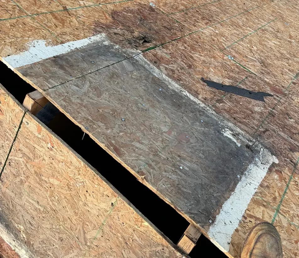rotted osb decking on a roof near the ridge