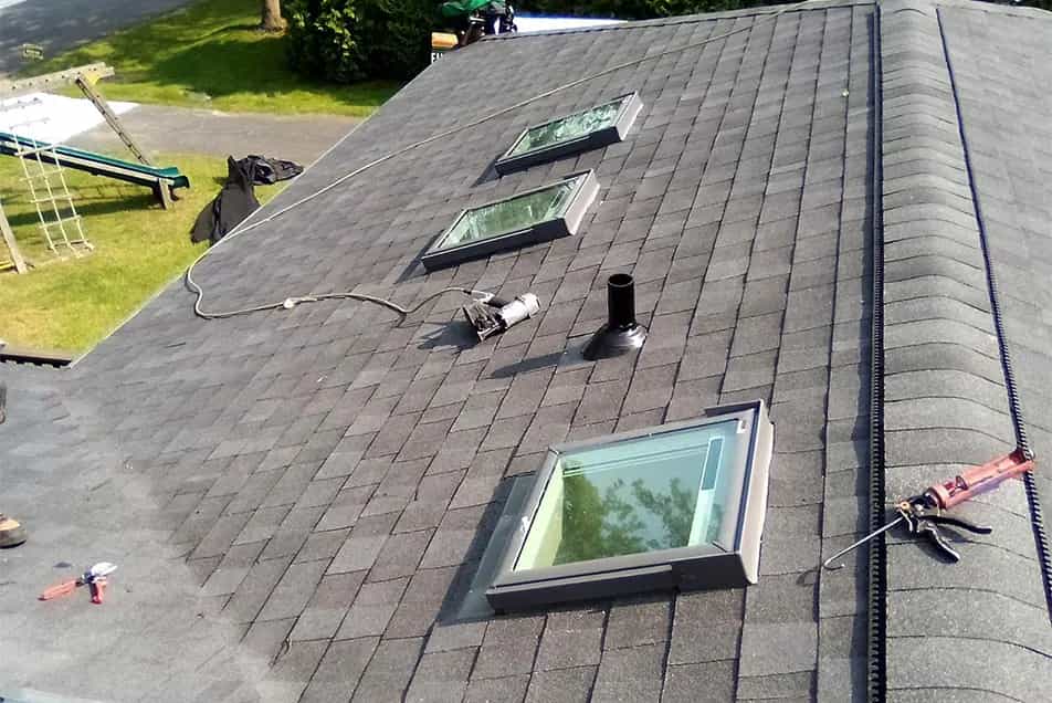 Skylights - Roof Replacement in SE Michigan three velux skylights on an asphalt shingle roof