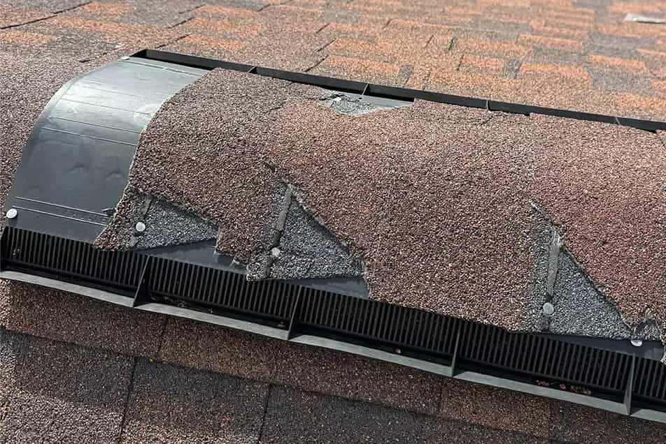 Damaged Ridge Cap - SE Michigan Storm Damage Roofing ridge cap shingles broken from a storm